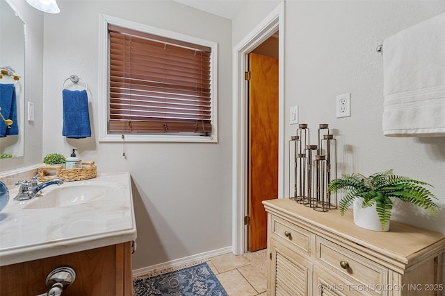 bathroom featuring tile patterned floors, vanity, and baseboards