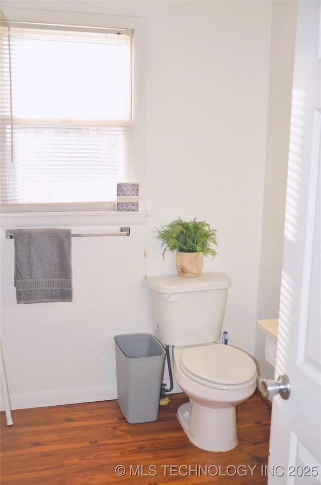 bathroom featuring toilet and wood finished floors