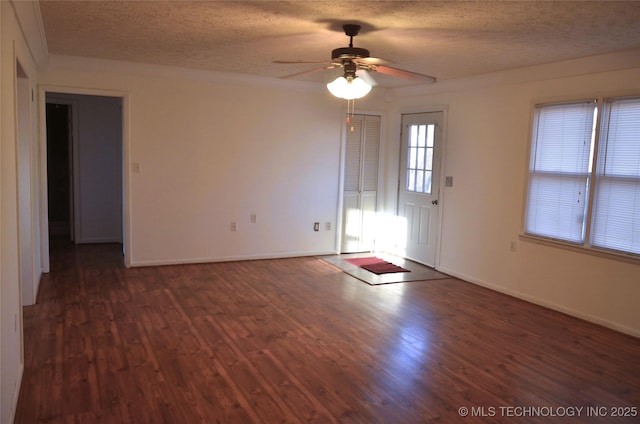 interior space with ceiling fan, a textured ceiling, and wood finished floors