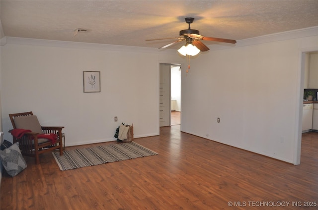 living area featuring wood finished floors, a ceiling fan, and ornamental molding