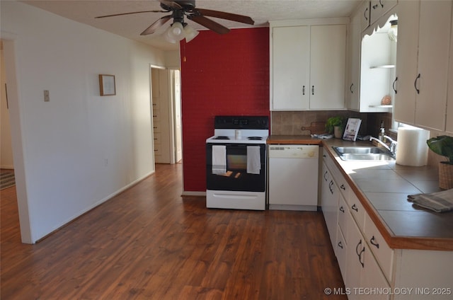 kitchen with a ceiling fan, white dishwasher, a sink, tile counters, and range with electric stovetop