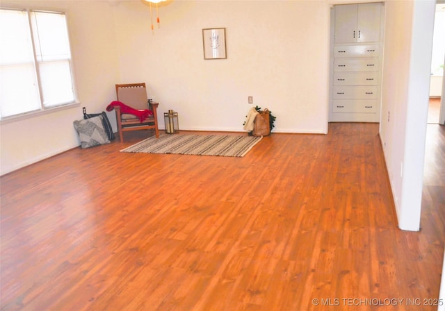 unfurnished room with wood finished floors