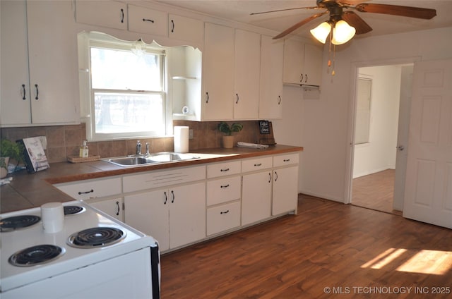 kitchen featuring a sink, white cabinetry, wood finished floors, and white range with electric cooktop