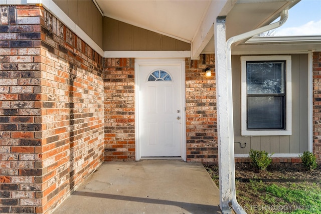 property entrance featuring brick siding