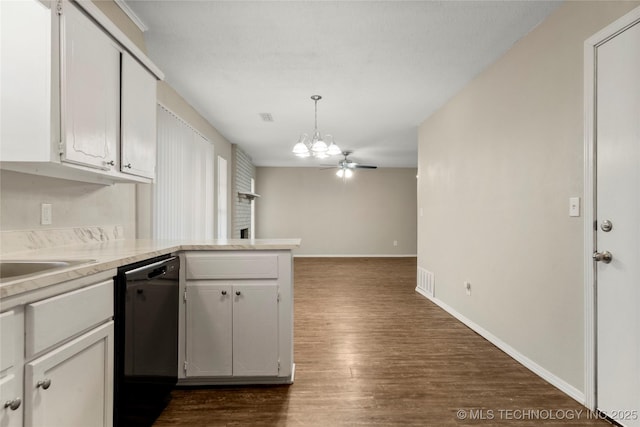 kitchen featuring baseboards, a peninsula, dark wood-style flooring, light countertops, and black dishwasher