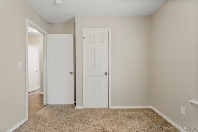 unfurnished bedroom featuring baseboards and carpet floors