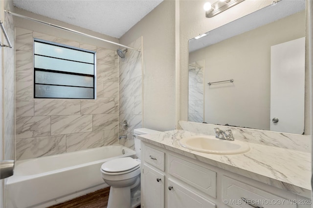 bathroom featuring vanity, a textured ceiling, wood finished floors, shower / bath combination, and toilet