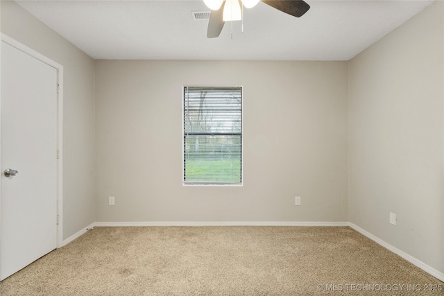 carpeted empty room featuring visible vents, baseboards, and ceiling fan