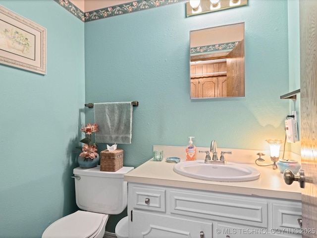 bathroom featuring toilet and vanity