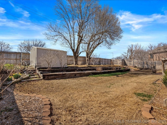 view of yard featuring an outdoor structure, a fenced backyard, and a storage shed