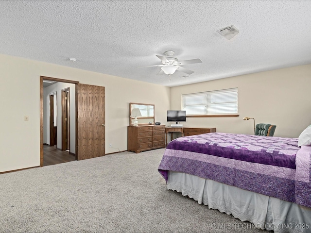 bedroom featuring carpet, baseboards, visible vents, ceiling fan, and a textured ceiling