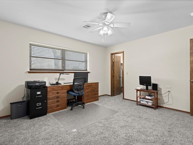 carpeted home office featuring visible vents, baseboards, and a ceiling fan