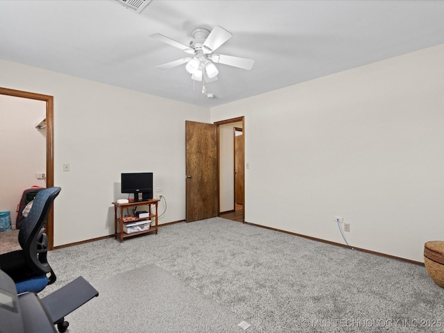 home office with baseboards, a ceiling fan, and carpet