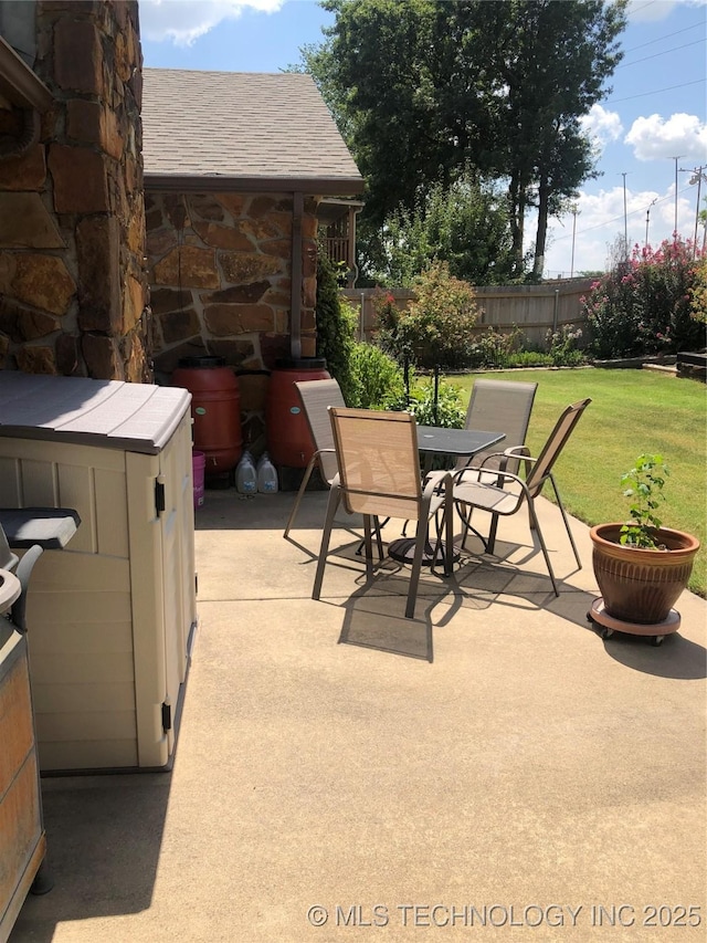 view of patio / terrace with outdoor dining area and fence