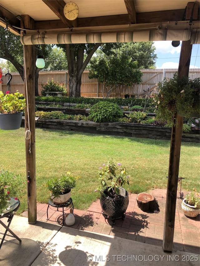 view of yard with a patio, a vegetable garden, and fence