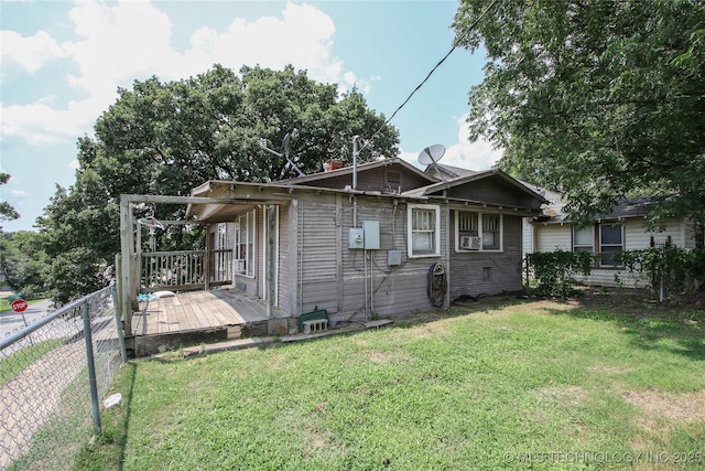 301 N Cleveland Ave, Sand Springs, OK 74063 - view of side of home featuring a lawn, a wooden deck, and fence