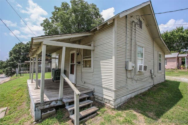 301 N Cleveland Ave, Sand Springs, OK 74063 - view of home's exterior featuring cooling unit and a yard