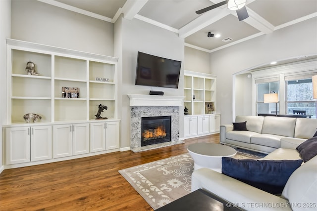 living area featuring visible vents, a fireplace, wood finished floors, coffered ceiling, and a ceiling fan