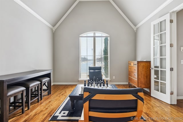 home office featuring baseboards, crown molding, lofted ceiling, and wood finished floors