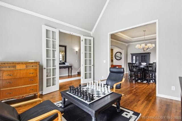 game room featuring ornamental molding, french doors, wood finished floors, arched walkways, and a notable chandelier