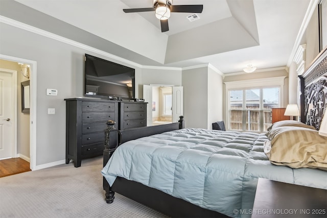 bedroom with visible vents, ornamental molding, baseboards, a raised ceiling, and light colored carpet