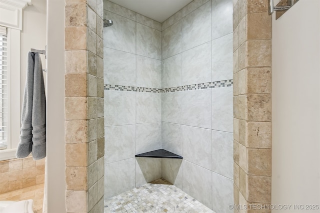 bathroom with tiled shower