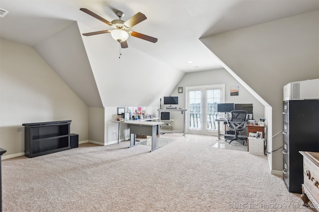 home office featuring visible vents, lofted ceiling, baseboards, light colored carpet, and ceiling fan