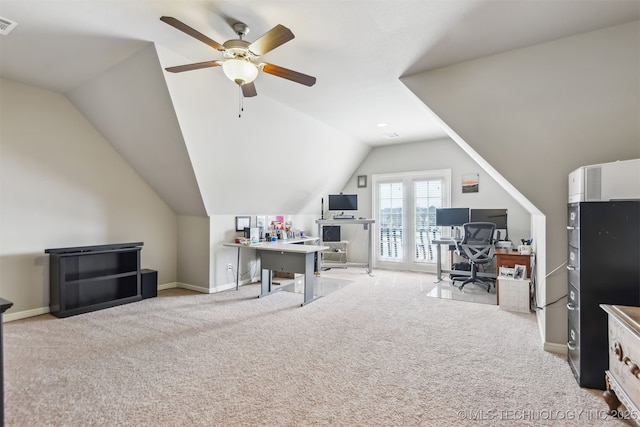 office space featuring baseboards, lofted ceiling, a ceiling fan, and light colored carpet