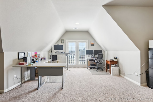 carpeted office space featuring visible vents, baseboards, and lofted ceiling