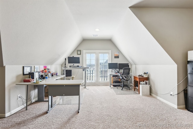 carpeted home office featuring vaulted ceiling, visible vents, and baseboards