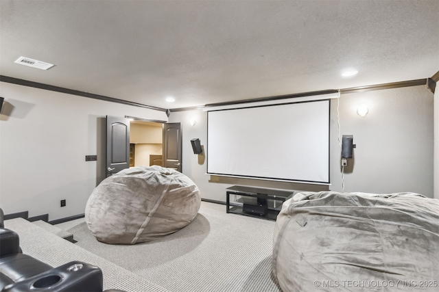 home theater room featuring visible vents, crown molding, baseboards, light colored carpet, and recessed lighting