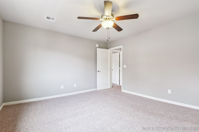 unfurnished room with visible vents, baseboards, carpet, and ceiling fan