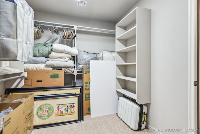 spacious closet with carpet flooring and visible vents