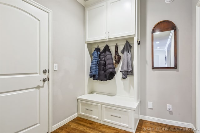 mudroom featuring baseboards and wood finished floors