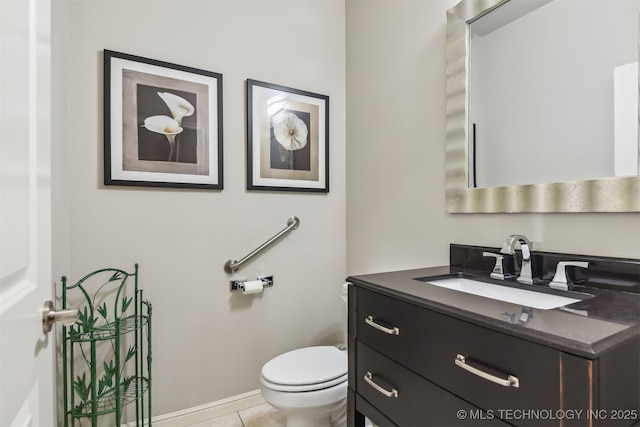 half bath with tile patterned floors, toilet, and vanity