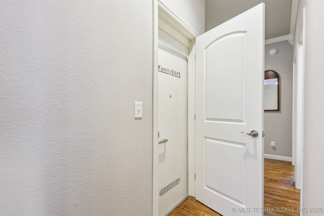 corridor featuring wood finished floors