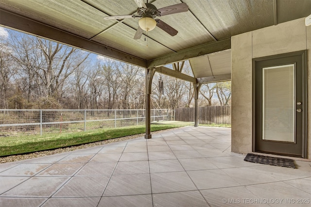 view of patio featuring a ceiling fan and fence