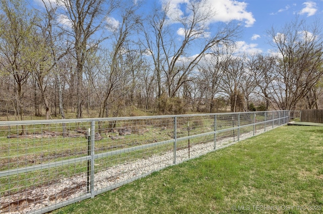 view of yard featuring a rural view and fence