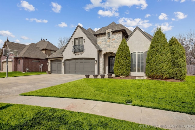 french country style house with a garage, stone siding, a front yard, and concrete driveway