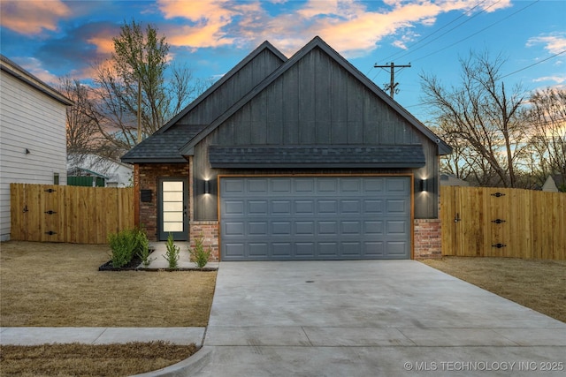 craftsman inspired home featuring a gate, brick siding, concrete driveway, and a shingled roof