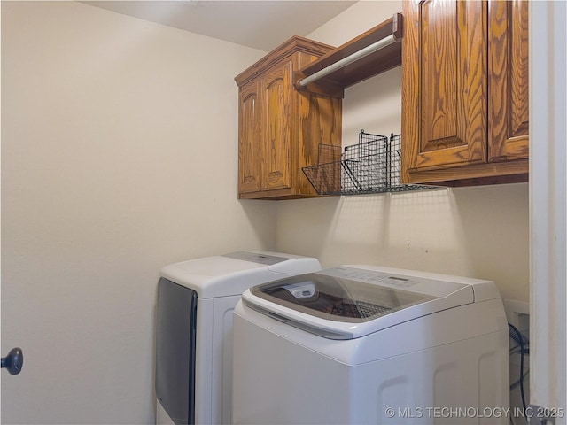 laundry room featuring cabinet space and separate washer and dryer