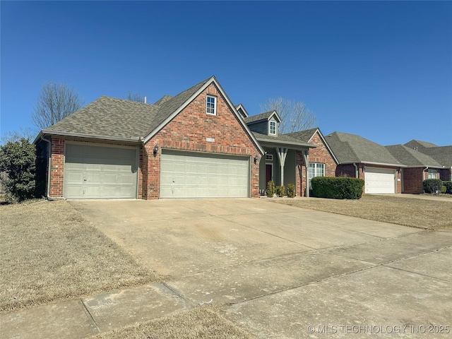 view of front of property featuring a garage, brick siding, roof with shingles, and concrete driveway