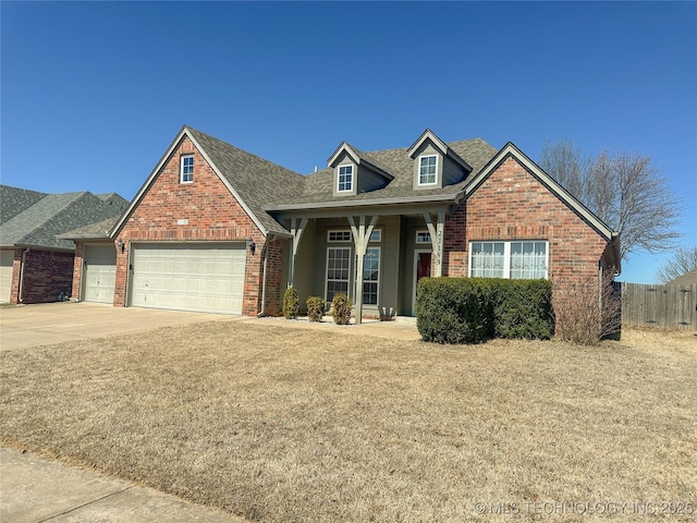 view of front of home featuring brick siding, fence, concrete driveway, roof with shingles, and an attached garage