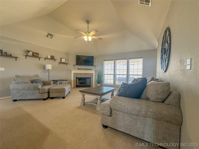 carpeted living room with vaulted ceiling, a ceiling fan, and visible vents