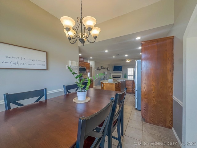 dining space featuring light tile patterned floors, a notable chandelier, recessed lighting, and baseboards