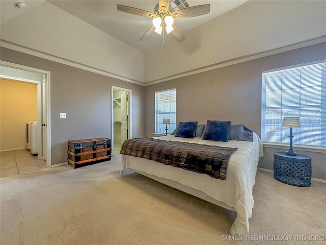 bedroom featuring carpet, baseboards, ceiling fan, vaulted ceiling, and a spacious closet