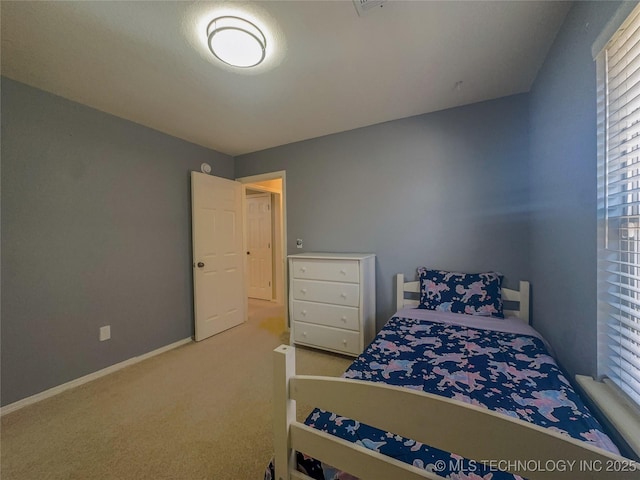 bedroom with carpet flooring and baseboards