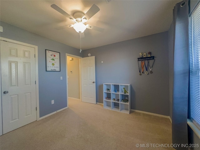 unfurnished bedroom with baseboards, carpet floors, and ceiling fan