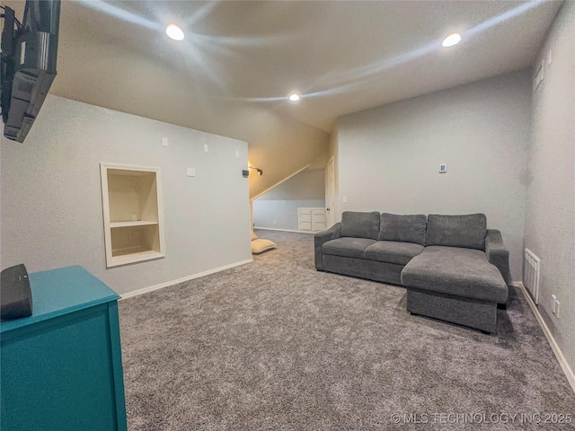 living area with built in features, carpet, visible vents, and baseboards