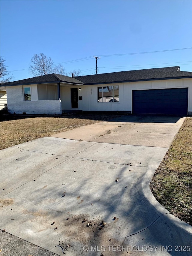 ranch-style home with brick siding, concrete driveway, an attached garage, and a shingled roof